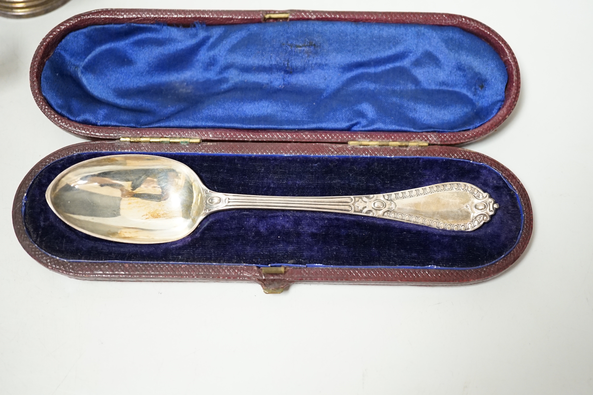 A George V silver christening mug, a cased Victorian silver christening spoon by George Adams and a plated christening mug.